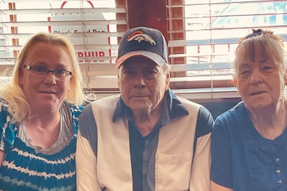 Stacy Kenkel poses for the camera with her parents, Larry and Mary