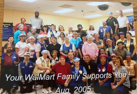 Christy Sawina (middle, in red) surrounded by her coworkers who wore head scarves in support of her cancer treatment journey