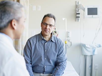 A doctor consults with a patient in an exam room