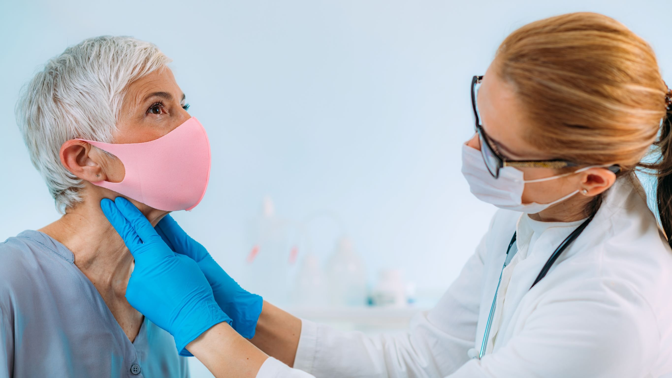 Patient with mask being examined by provider with mask