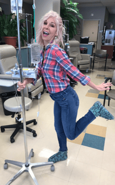 Angela Huhman poses with an intravenous drip