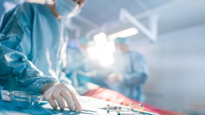 Medical professionals work with surgical instruments during an operation