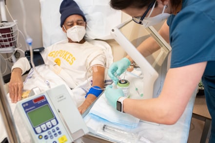 Nurse administering injectable radiotherapy for neuroendocrine patient