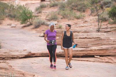 Two women walking on a trail