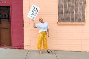 Anna holding a sign that says I won