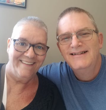 breast cancer survivor and husband get matching hairstyles