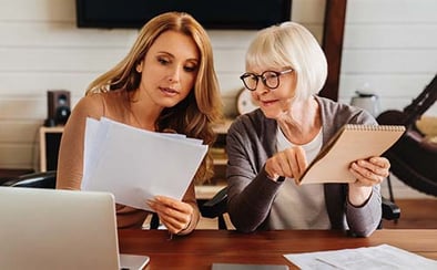 woman reading advance care planning documents with parent