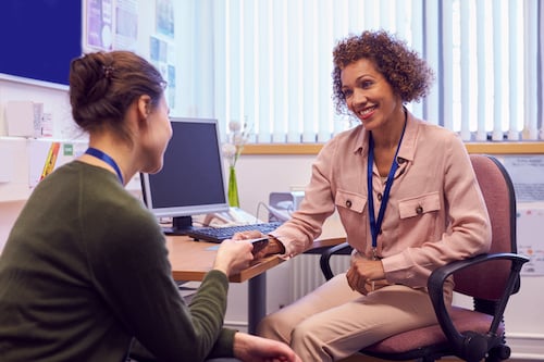 two women speaking together in an office