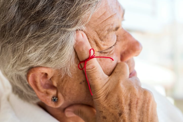 Older person with ribbon on finger chemo side effects memory loss