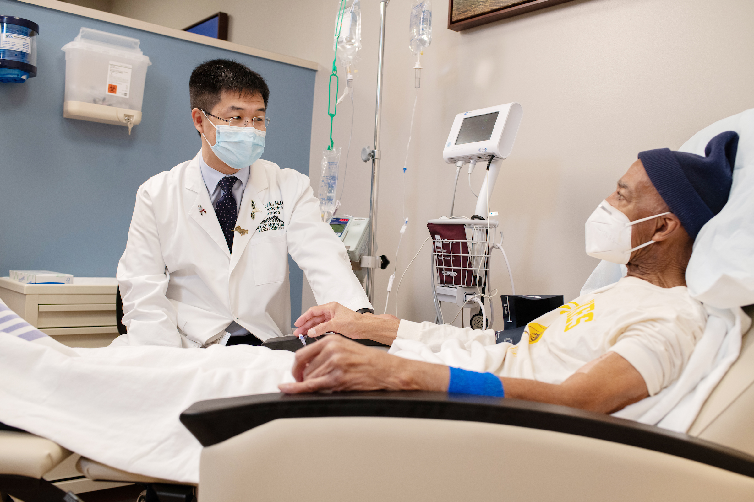 doctor with mask talking to patient with mask